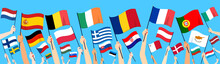 Close Up Of Hands Rising Up 27 European Union Member Countries Flags On Blue Background
