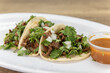 Hearty side order of carne asada steak street tacos filled with meat, cilantro, and onions