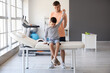 © Pixel-Shot - Physiotherapist working with boy in rehabilitation center