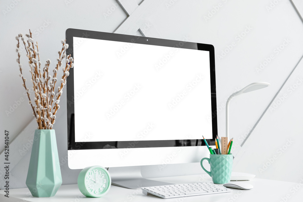Stylish workplace with modern computer on light background