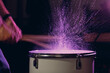 Close up drum sticks drumming hit beat rhythm on drum surface with splash water drops with long exposure blur