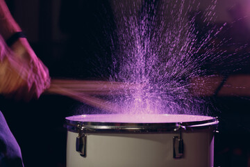 Wall Mural - Close up drum sticks drumming hit beat rhythm on drum surface with splash water drops with long exposure blur