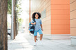 © PintoArt - little boy, afro hair walking with backpack back to school happy going to class