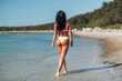 © Syda Productions - people, summer and swimwear concept - young woman in bikini swimsuit on beach