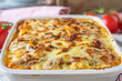 © Angelika Heine - Lasagne with ragu alla bolognese, bechamel sauce and mozzarella cheese in a casserole dish. Closeup and front view