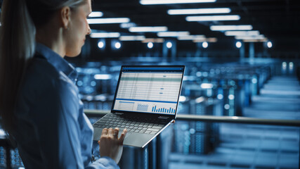 Leinwandbilder - Data Center Female IT Specialist Uses Laptop Computer. Cloud Computing Server Farm with IT Engineer Monitoring Statistic, Maintenance Control. Information Technology of Fintech, e-Business.