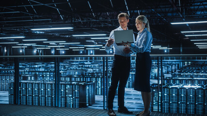 Poster - Data Center Female e-Business Enrepreneur and Male IT Specialist talk, Use Laptop. Two Information Technology Engineers work on Bridge Big Cloud Computing Server Farm.