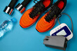 Sneakers, dumbbells and blood pressure monitor on a blue background