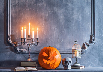 Canvas Print - Scary laughing pumpkin and old skull on ancient gothic fireplace. Halloween, witchcraft and magic.