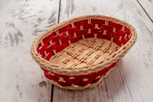 Beautiful Red Wicker Basket On A Wooden Table.