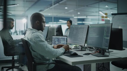 Multi-Ethnic Office: Black IT Programmer Working on Desktop Computer. Male Specialist DoingWebsite, Software Engineer Developing App, Program, Video Game. Terminal with Coding Language. Static Shot