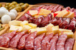 Cold cuts board with salami and different types of cheese