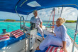 © TRAVEL EASY - Senior and young couples, family, enjoying sailing trip on a luxury summer holiday vacation, sunset and ocean in background, love and romance on a beautiful yacht at the helm