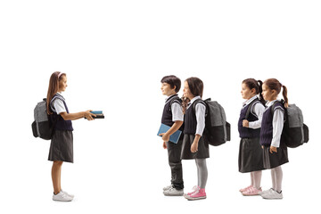 Poster - Schoolgirl giving books to a group of younger schoolchildren in uniforms