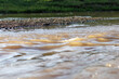selective focus rocks river bank water level is rising The view background image from the water has to space for text