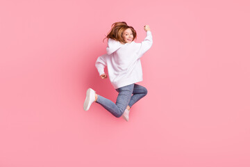 Poster - Full length body size view of attractive funky cheerful girl jumping running isolated over pink pastel color background