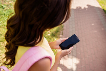 Poster - Top above high angle view cropped photo of young girl look use smartphone mobile touchscreen summer nature outdoors