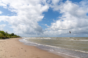 Sticker - empty sandy beach and single kite surfer in the Baltic Sea near Pavilosta in Latvia