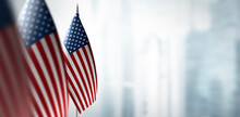 Small Flags Of United States On The Background Of A Blurred Background