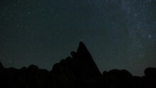 Time Lapse Of Star Trails Over Pinnacle Rock Formation At Alabama Hills In California