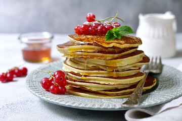 Wall Mural - Delicious hot pancakes with fresh berries and maple syrup for a breakfast.