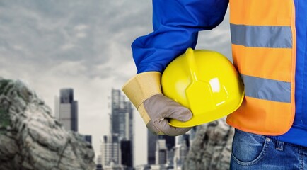 Wall Mural - Worker man with helmet in hands on background