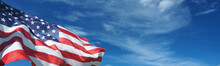 USA Flag On A Background Of Blue Sky. National Holidays Concept