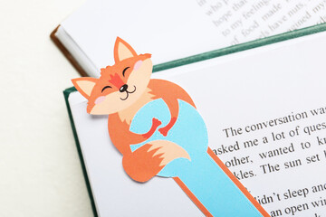 Wall Mural - Cute bookmark with books on white background, closeup