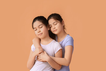 Wall Mural - Cute little sisters on color background