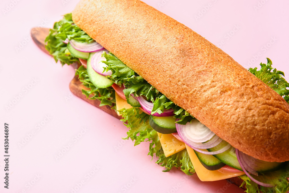 Board with tasty sandwich on color background, closeup