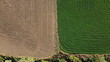 top down image of the seperation and contrast between a harvested field and a plowed field in rural agricultural farmland, Australia