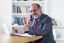 Brazilian Senior Businessman Talking With Customer At Phone