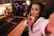 © Drobot Dean - Smiling young woman gamer in headphones