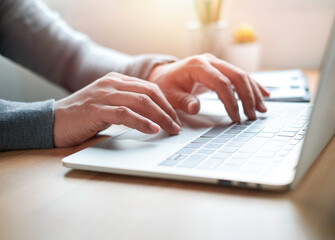 Close-up of man hand using and typing keyboard of laptop computer on office desk. Workspace, businessman working project creative idea for job online network. Business finance and technology concept.