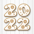 Christmas gingerbread cookies with the date 2022 on a white background. 
New year greeting card. View from above. Christmas vacation. Xmas festive holiday.
