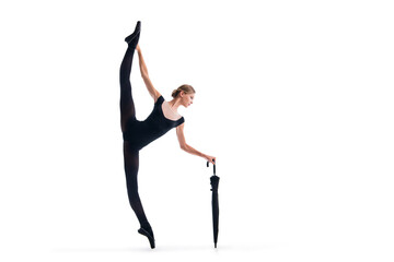 a young ballerina in black pointe shoes and leotard posing with umbrella in graceful pose isolated on white background