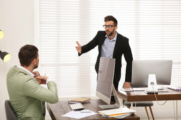 Wall Mural - Emotional colleagues arguing in office. Toxic work environment