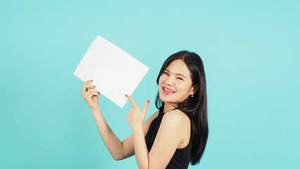 Wall Mural - Blank empty paper in asian woman's hand and pointing finger on mint green or Tiffany Blue background.