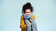 © LIGHTFIELD STUDIOS - woman in warm sweater and scarf hugging herself while freezing isolated on blue