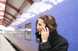 © Johnér - Man talking on phone at train station