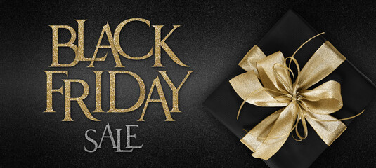 gift card, Black Friday sale text and black package wrapped with golden ribbon bow isolated on black background, template for promotional banner with copy space