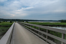 A Long Wood Walkway Over The Wetland To The Beach