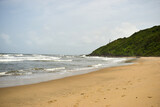 Fototapeta Do akwarium - Ocean-Sea Waves Beach Sand and Mountains Yellow Landscape Background