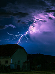 Wall Mural - bolt from the blue: a branching bolt of lightning strikes down far away from the storm