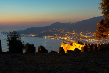 Wall Mural - View from the fortress. Stone walls. Lighting and night atmosphere. Touristic point. View of the city lights. Leisure and tourism in Turkey, Alanya