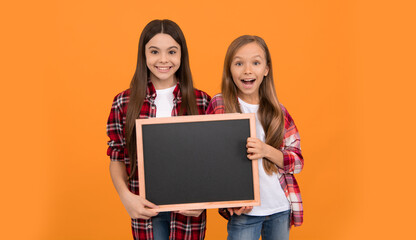 Poster - happy teen girls hold blackboard. children advertising. back to school. kids presenting information