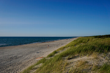 Sticker - beautiful idyllic endless white sand beach with a calm ocean and gentle waves and sand dunes