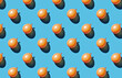 Pattern of orange balloons on blue pastel background