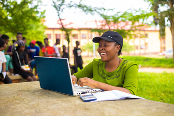 close up of a beautiful african lady studying in the school campus feeling excited