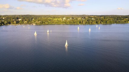 Wall Mural - Sailboat on lake Starnberg. Munich residents and vacationers sail and relax on the idyllic mountain lake in Bavaria. Aerial view from drone